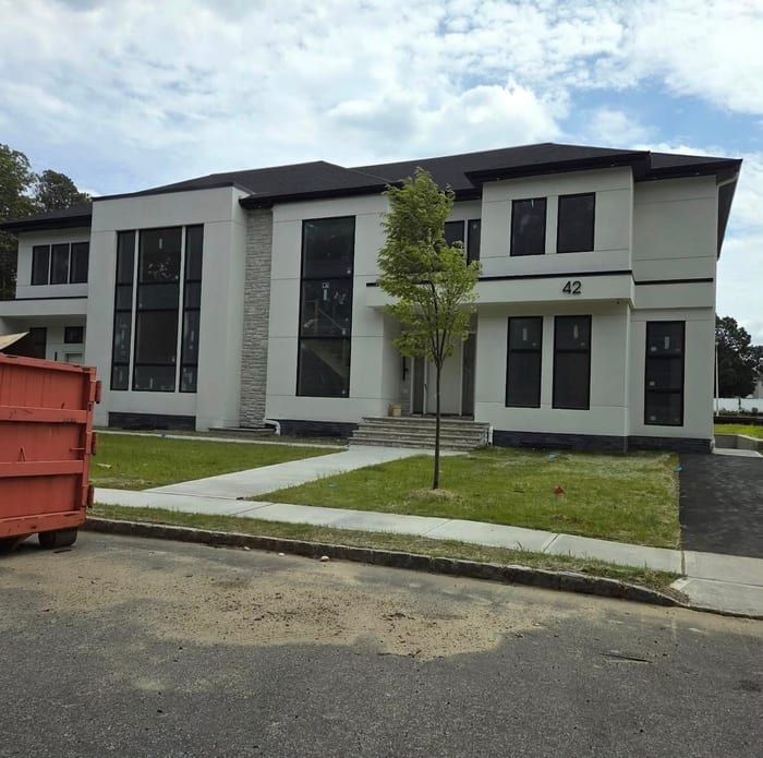 A modern two-story home where HD Installs wired security cameras and access control, in daylight.
