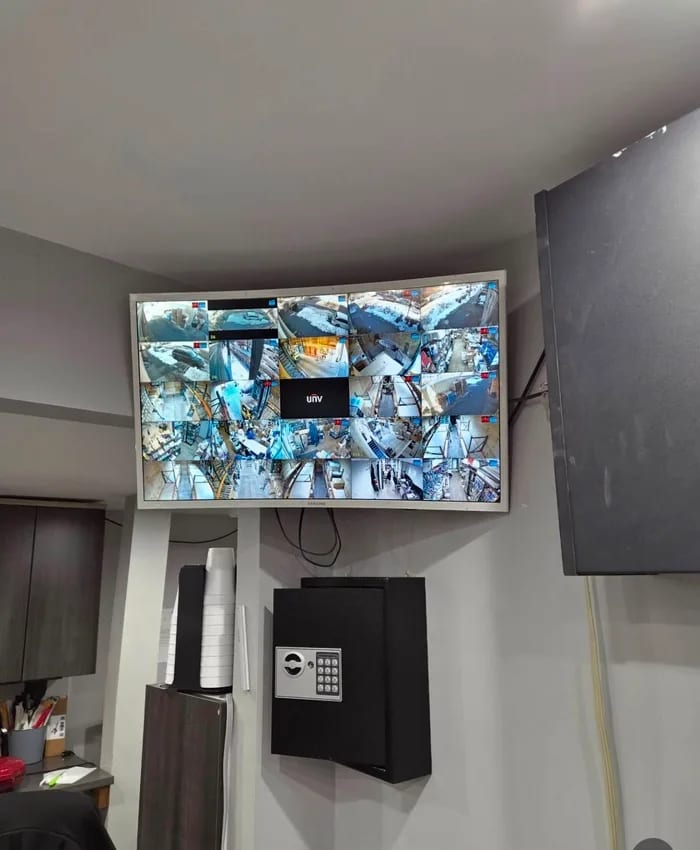 A multi-camera monitor wall HD Installs installed for a small business, in daylight.